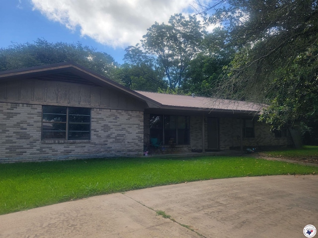 102 Hall St, New Boston, TX 75570 - ranch-style home with a front lawn, brick siding, and board and batten siding