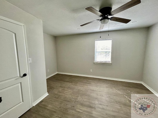 spare room with dark wood-type flooring, a textured ceiling, and ceiling fan