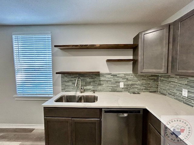 kitchen featuring sink, dishwasher, and dark brown cabinets