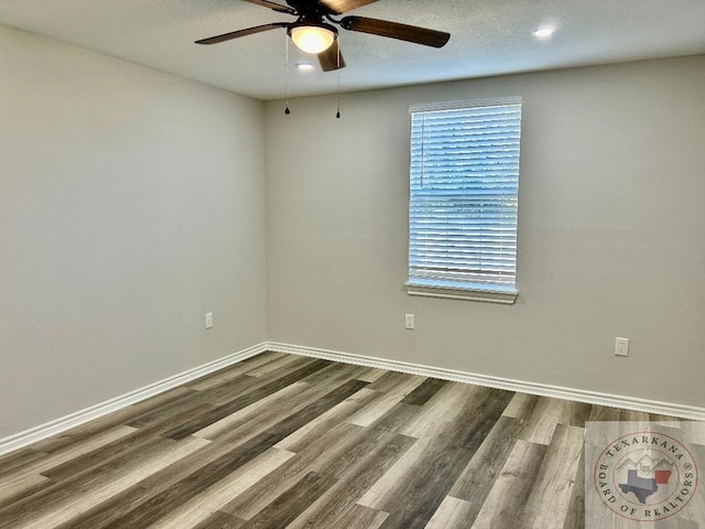 spare room with ceiling fan and hardwood / wood-style floors