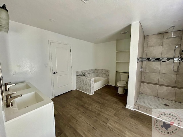 full bathroom featuring hardwood / wood-style floors, separate shower and tub, toilet, and vanity