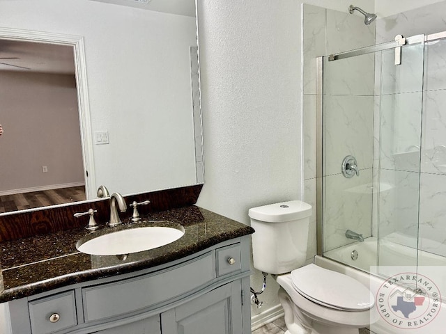 full bathroom featuring toilet, vanity, and combined bath / shower with glass door