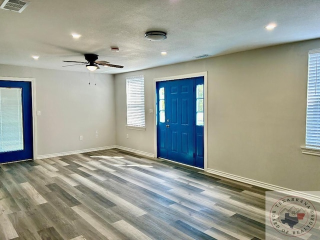 entrance foyer featuring ceiling fan, light hardwood / wood-style flooring, and a textured ceiling