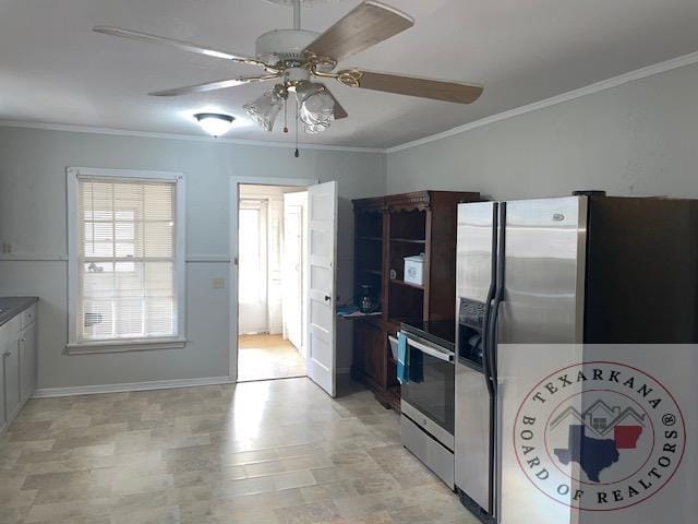 kitchen with appliances with stainless steel finishes, ornamental molding, and ceiling fan