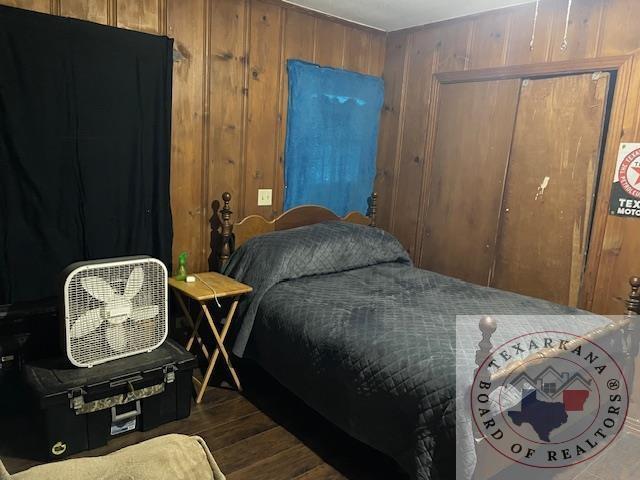 bedroom with wood walls