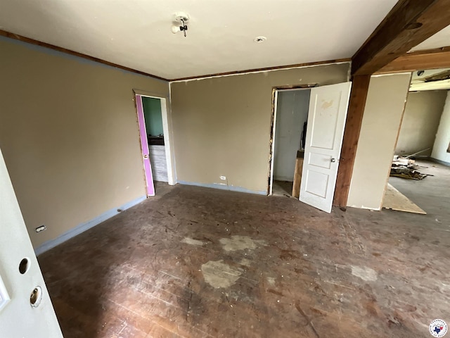 unfurnished bedroom featuring baseboards, ornamental molding, and a closet