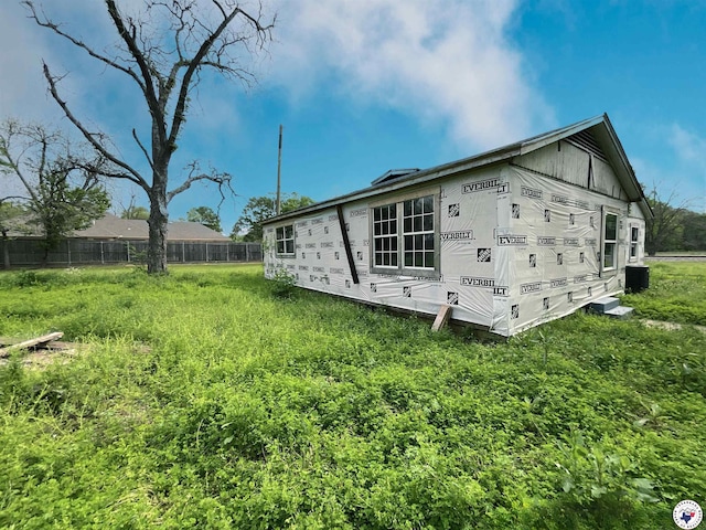 view of home's exterior with fence and cooling unit