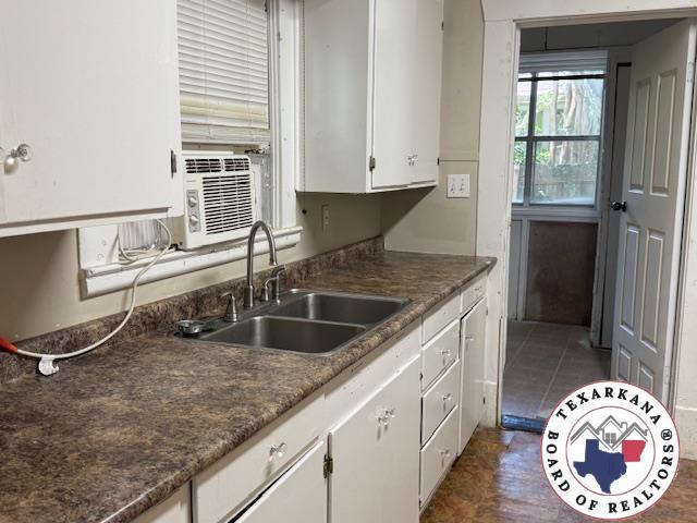 2308 Laurel St, Texarkana, AR 71854 - kitchen featuring white cabinets and dark countertops