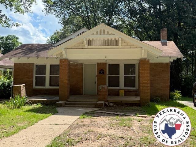 2308 Laurel St, Texarkana, AR 71854 - view of front of property with brick siding, a porch, and a chimney