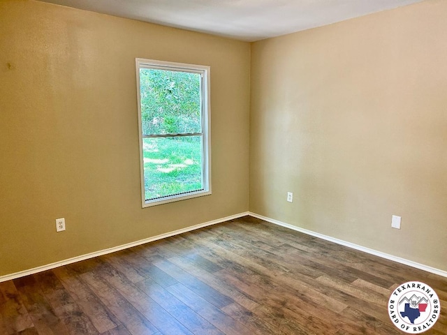 704 Florence St, Atlanta, TX 75551 - spare room featuring dark wood-style floors and baseboards