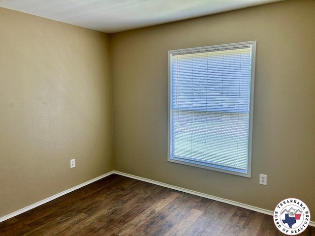 704 Florence St, Atlanta, TX 75551 - unfurnished room with baseboards and dark wood-type flooring