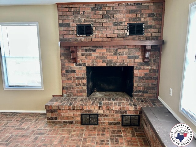 704 Florence St, Atlanta, TX 75551 - detailed view of baseboards and a fireplace