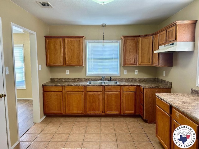 704 Florence St, Atlanta, TX 75551 - kitchen with a sink, brown cabinets, and healthy amount of natural light