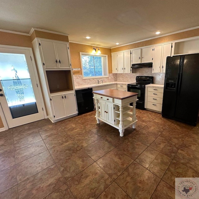 kitchen with sink, white cabinetry, black appliances, and a kitchen island