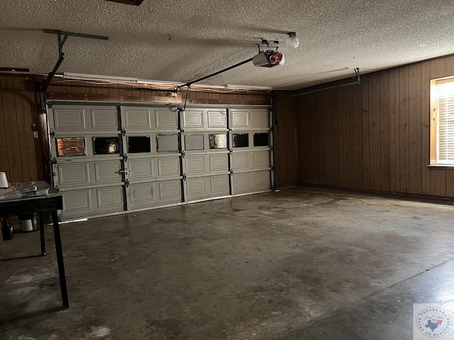 garage with a garage door opener and wooden walls