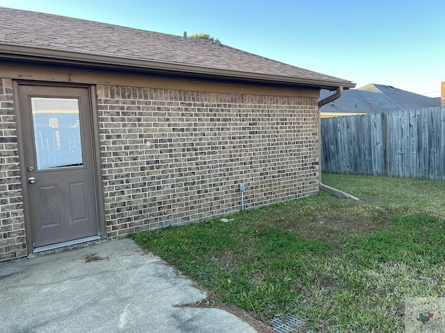 view of side of property with a yard