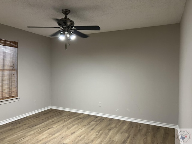 spare room with ceiling fan, a textured ceiling, and light wood-type flooring