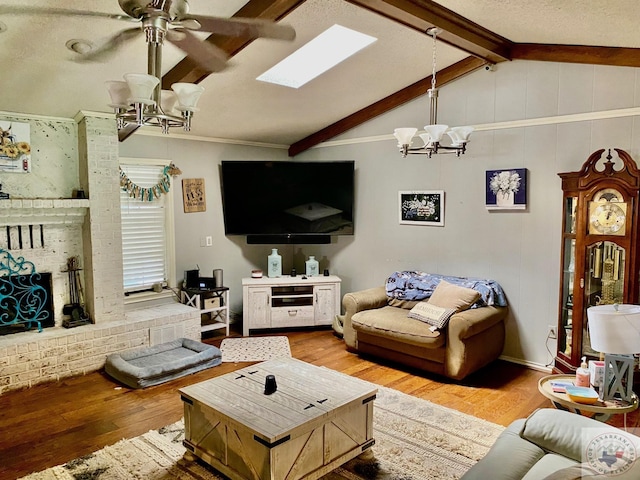 living room with hardwood / wood-style flooring, ceiling fan with notable chandelier, vaulted ceiling with beams, and a textured ceiling