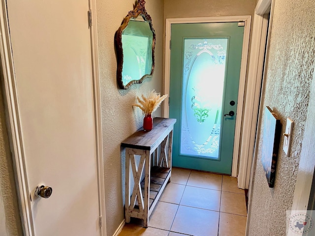 doorway to outside featuring light tile patterned floors