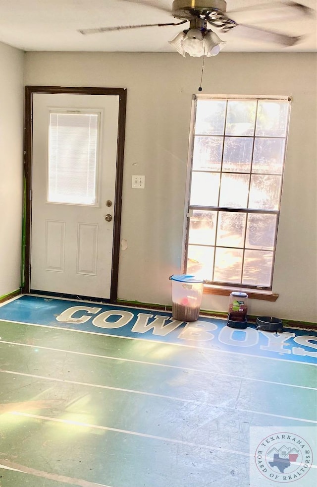 entrance foyer with ceiling fan