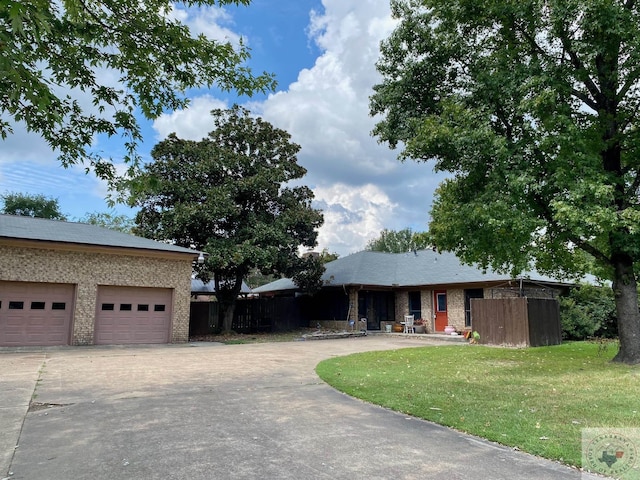 view of front of home with a garage and a front lawn