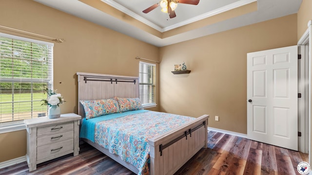 bedroom featuring baseboards, crown molding, a ceiling fan, and dark wood-type flooring