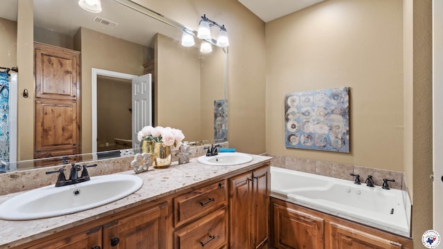 bathroom featuring double vanity, a garden tub, visible vents, and a sink
