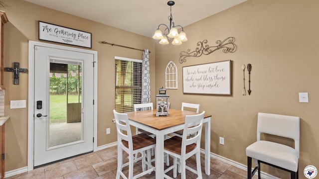 dining area with a chandelier and baseboards