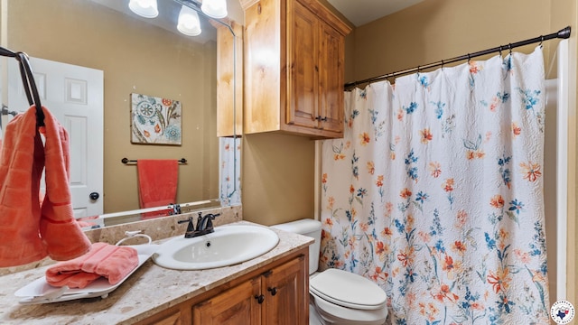 bathroom featuring toilet, vanity, and a shower with curtain