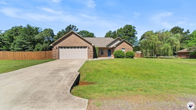 single story home with fence, an attached garage, a front lawn, and brick siding