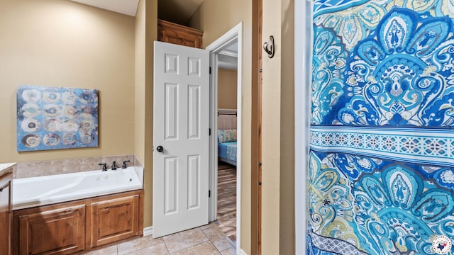 bathroom with connected bathroom, a garden tub, and tile patterned floors