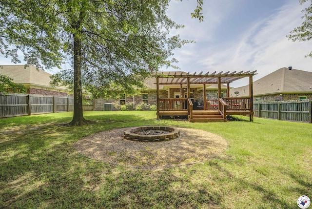 3428 Garrett Ln, Texarkana, TX 75503 - fenced backyard featuring an outdoor fire pit, a pergola, and a deck