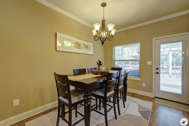 3428 Garrett Ln, Texarkana, TX 75503 - dining room with a chandelier, ornamental molding, and light wood-type flooring