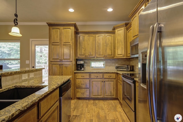 3428 Garrett Ln, Texarkana, TX 75503 - kitchen with appliances with stainless steel finishes, crown molding, light wood-style floors, decorative backsplash, and decorative light fixtures