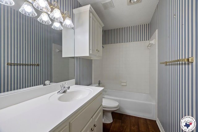 6102 Deerfield Dr, Texarkana, TX 75503 - full bath with wallpapered walls, wood finished floors, toilet, vanity, and a textured ceiling