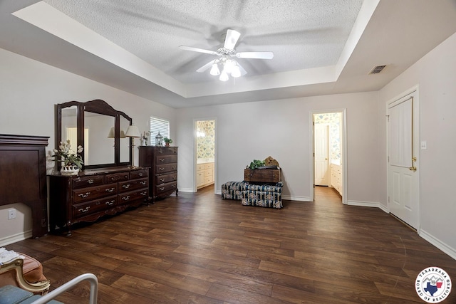 6102 Deerfield Dr, Texarkana, TX 75503 - bedroom featuring a raised ceiling, dark wood finished floors, baseboards, a textured ceiling, and ensuite bathroom