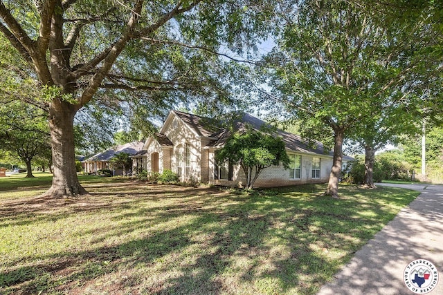 6102 Deerfield Dr, Texarkana, TX 75503 - view of side of property with brick siding and a lawn