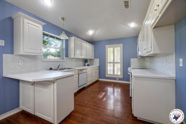 6102 Deerfield Dr, Texarkana, TX 75503 - kitchen featuring white dishwasher, a sink, white cabinetry, a textured ceiling, and a peninsula