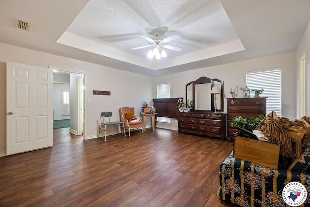 6102 Deerfield Dr, Texarkana, TX 75503 - bedroom with a raised ceiling, dark wood finished floors, baseboards, a textured ceiling, and ceiling fan