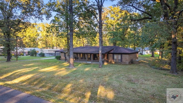 single story home with a porch and a front lawn