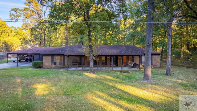 ranch-style house with covered porch and a front yard