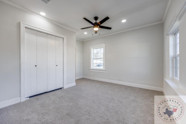 908 W Washington St, Clarksville, TX 75426 - unfurnished bedroom featuring ceiling fan, ornamental molding, light carpet, and a closet
