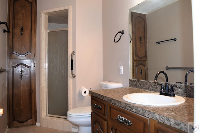 bathroom featuring vanity, toilet, tile patterned floors, and a shower with door