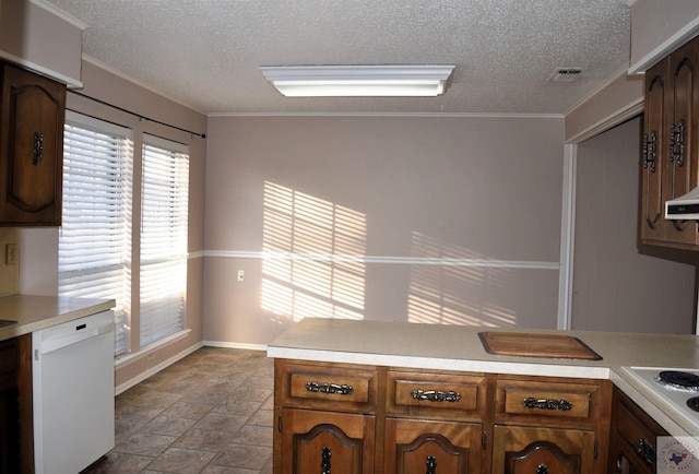 kitchen with white appliances, a textured ceiling, and ornamental molding