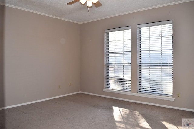 spare room with ceiling fan, a textured ceiling, ornamental molding, and carpet flooring