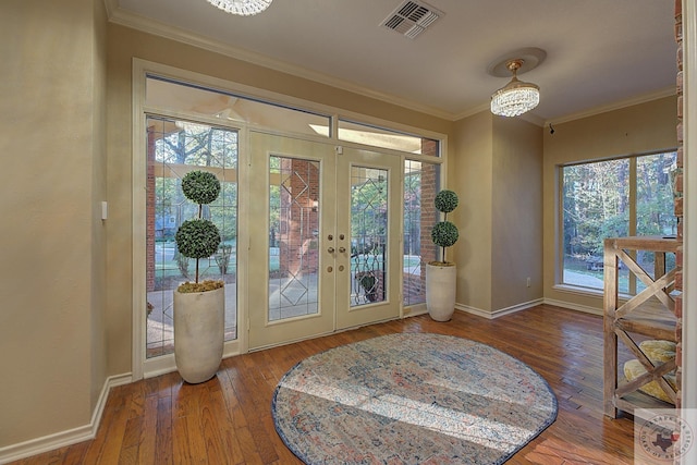 entryway featuring french doors, crown molding, plenty of natural light, and hardwood / wood-style floors