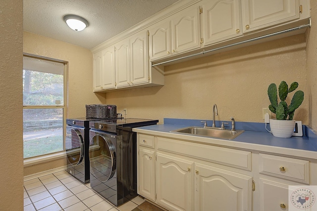 kitchen with a textured ceiling, white cabinetry, sink, independent washer and dryer, and light tile patterned floors