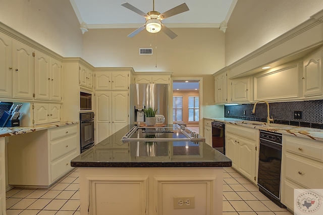 kitchen with a kitchen island, light tile patterned flooring, black appliances, and tasteful backsplash