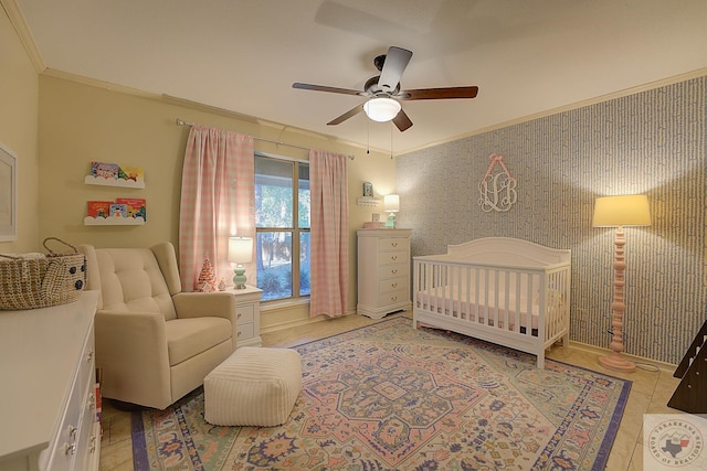 tiled bedroom with crown molding, ceiling fan, and a nursery area