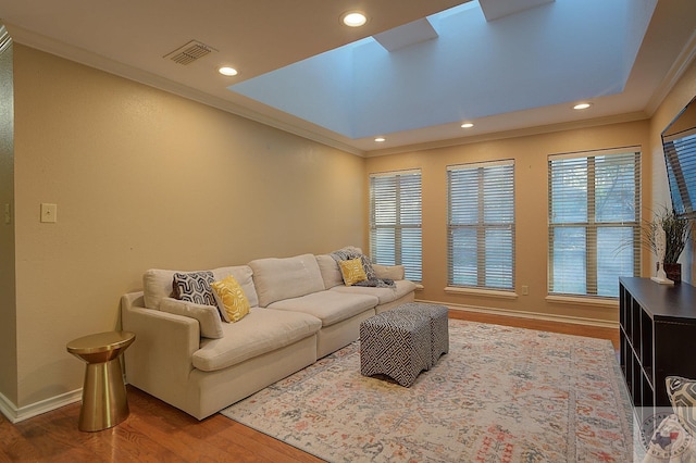 living room featuring hardwood / wood-style flooring and ornamental molding